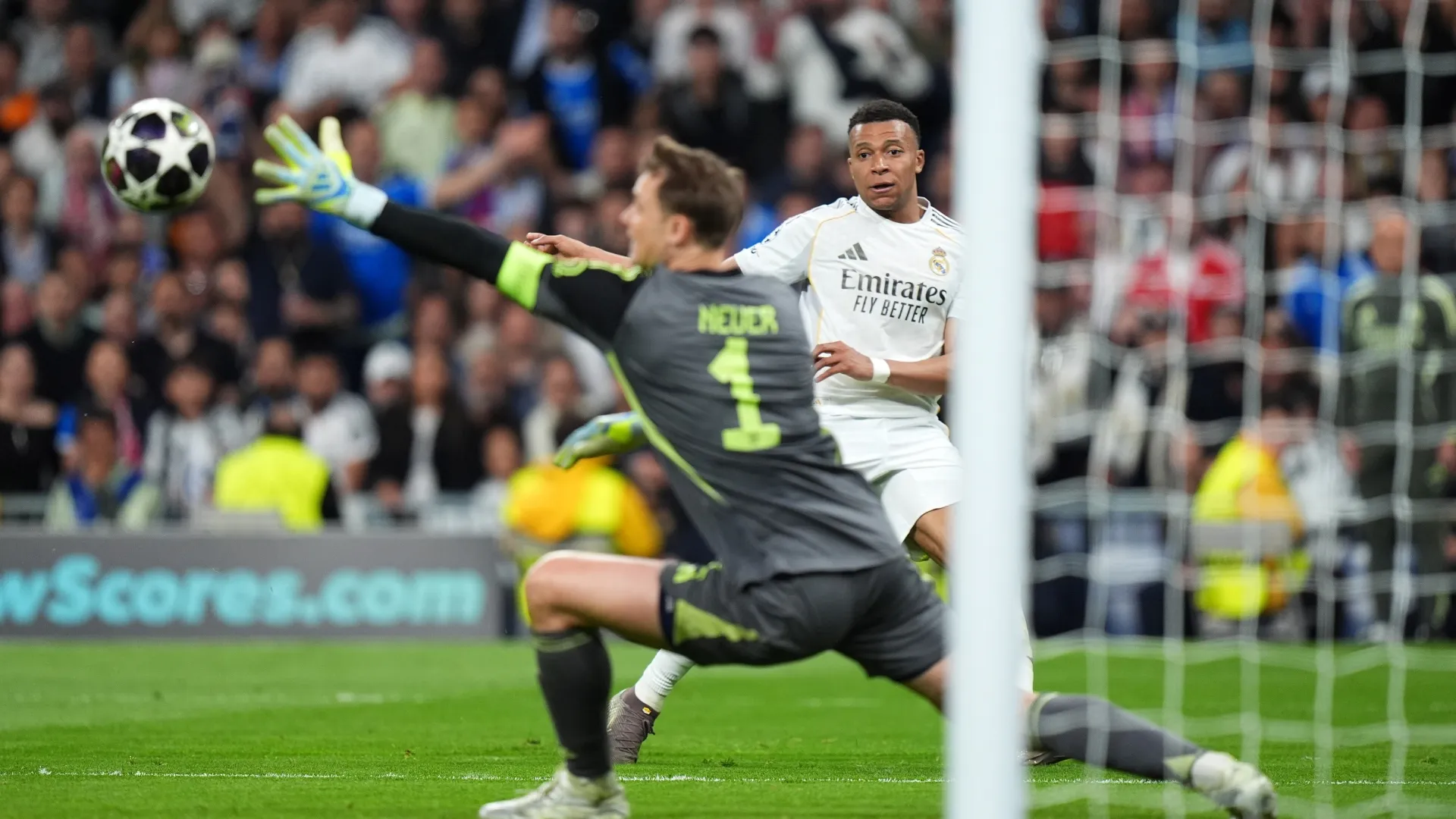 Kylian Mbappe of Real Madrid attempts to shoot past Manuel Neuer of FC Bayern Munich.