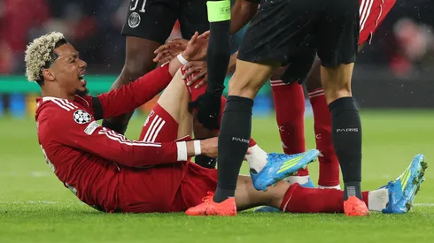 Hugo Ekitike of Liverpool holds his ankle as he appears to be injured