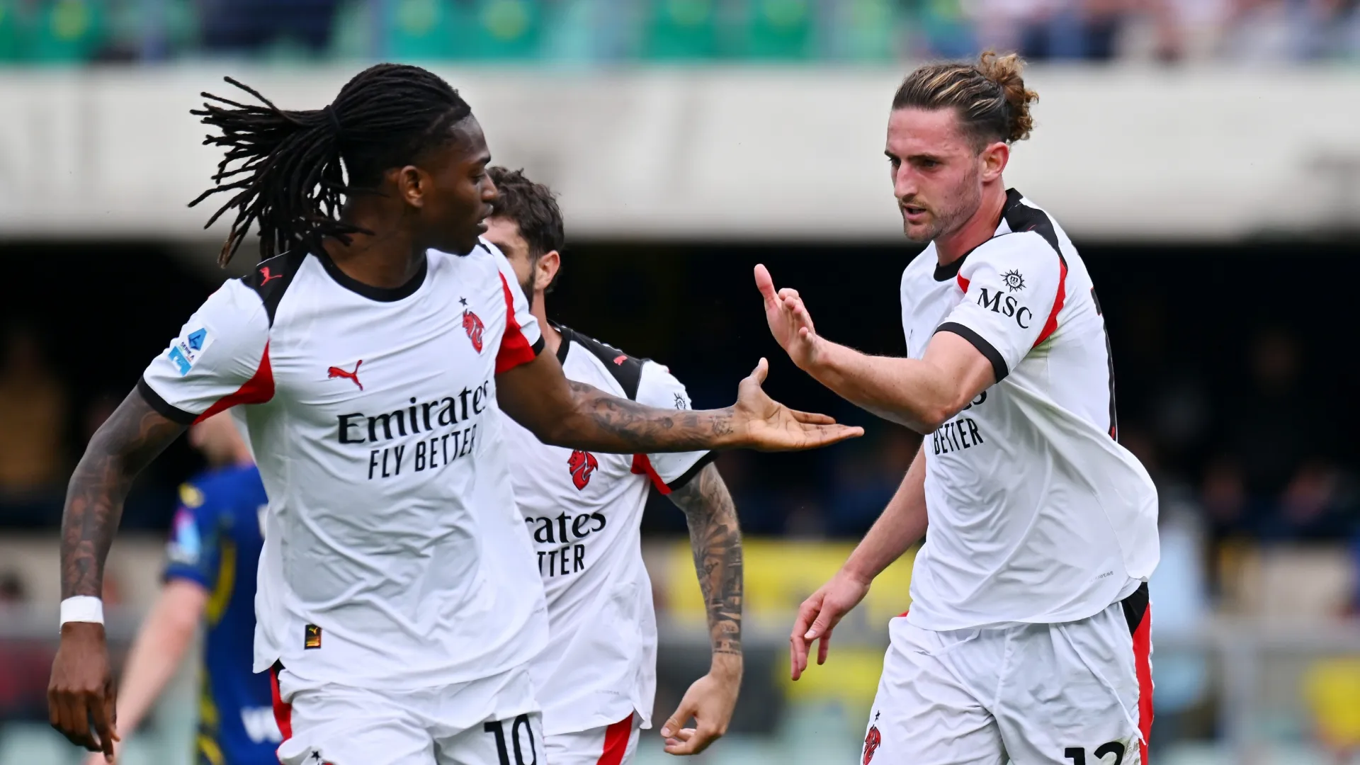 Adrien Rabiot of AC Milan celebrates scoring against Hellas Verona with Rafael Leao.