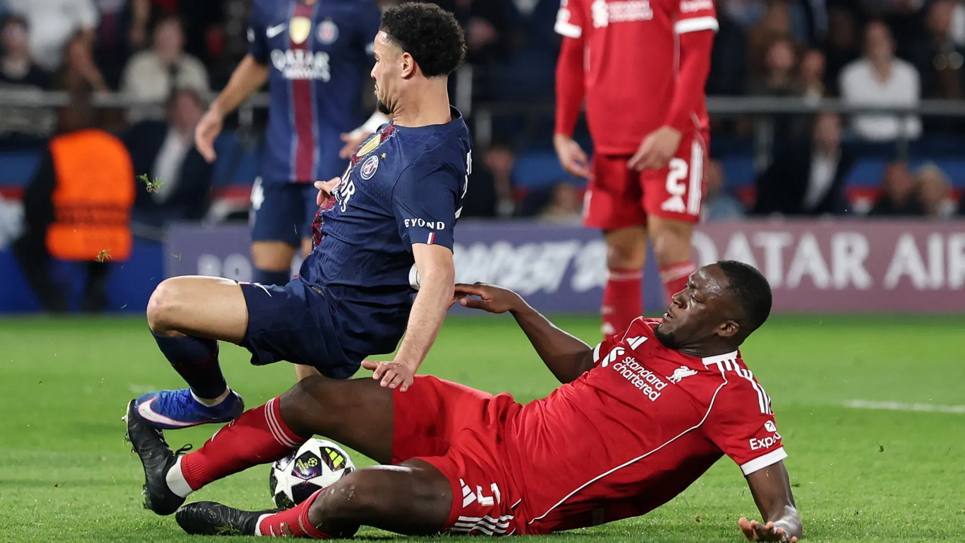Warren Zaire-Emery of Paris Saint-Germain is tackled by Ibrahima Konate of Liverpool.