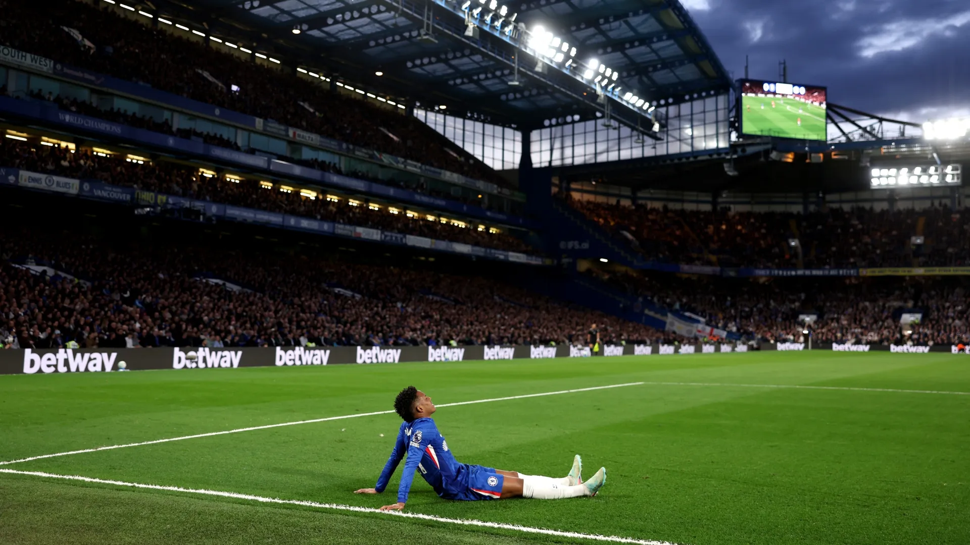 Estevao of Chelsea reacts with an injury during the game against Manchester United.