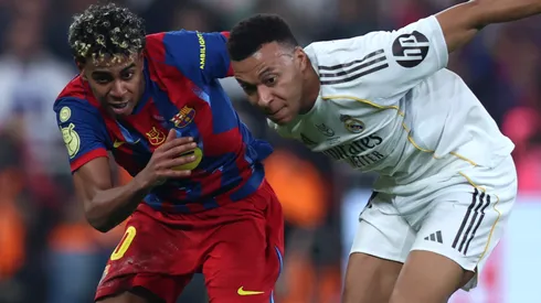 Kylian Mbappe of Real Madrid battles for possession with Lamine Yamal of FC Barcelona