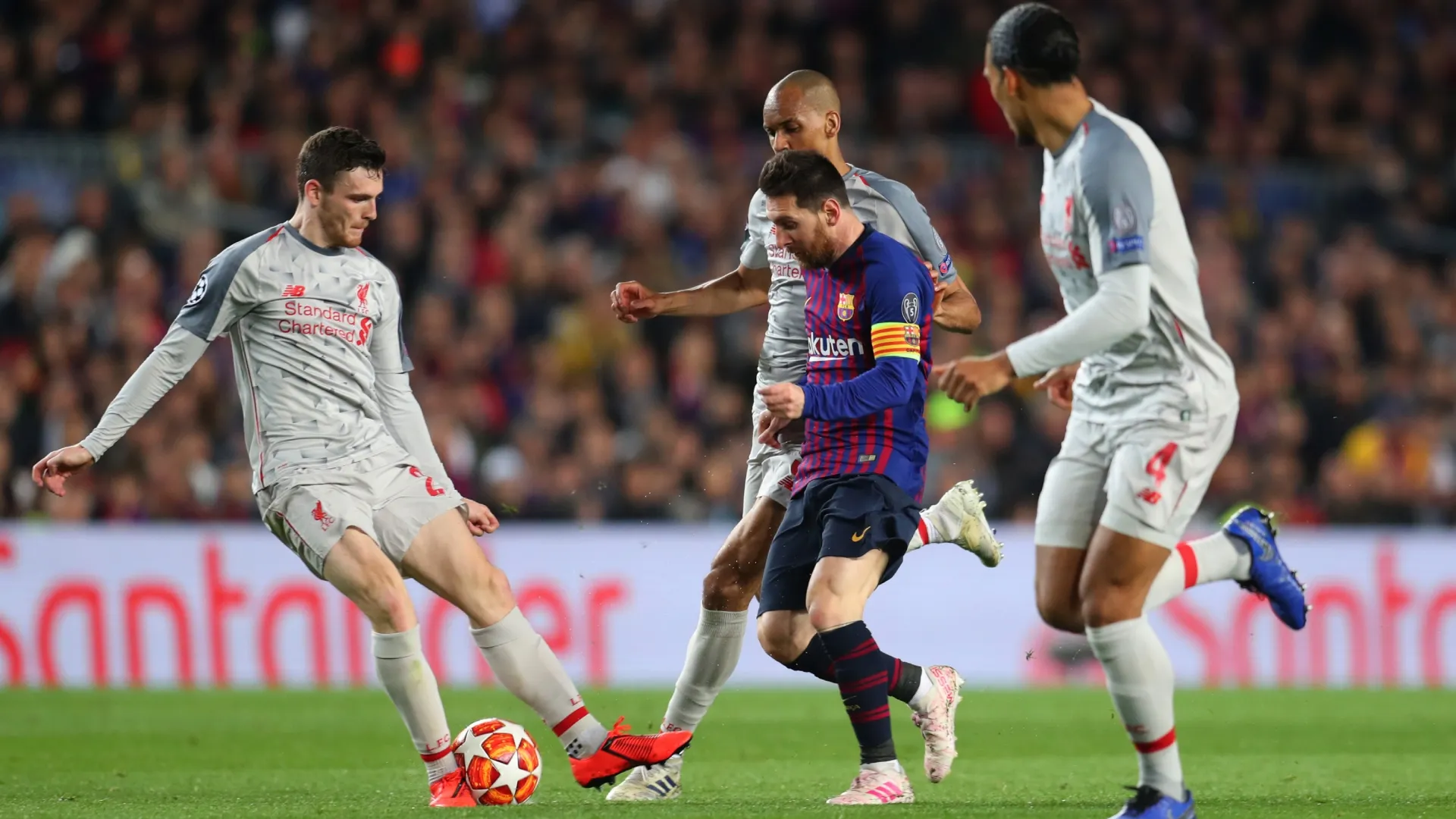 Lionel Messi of Barcelona is marked by Andrew Robertson, Fabinho and Virgil van Dijk of Liverpool.