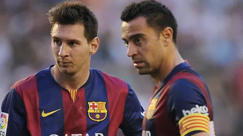 Barcelona's Xavi Hernandez (R) and Lionel Messi line-up a free kick during the La Liga match.