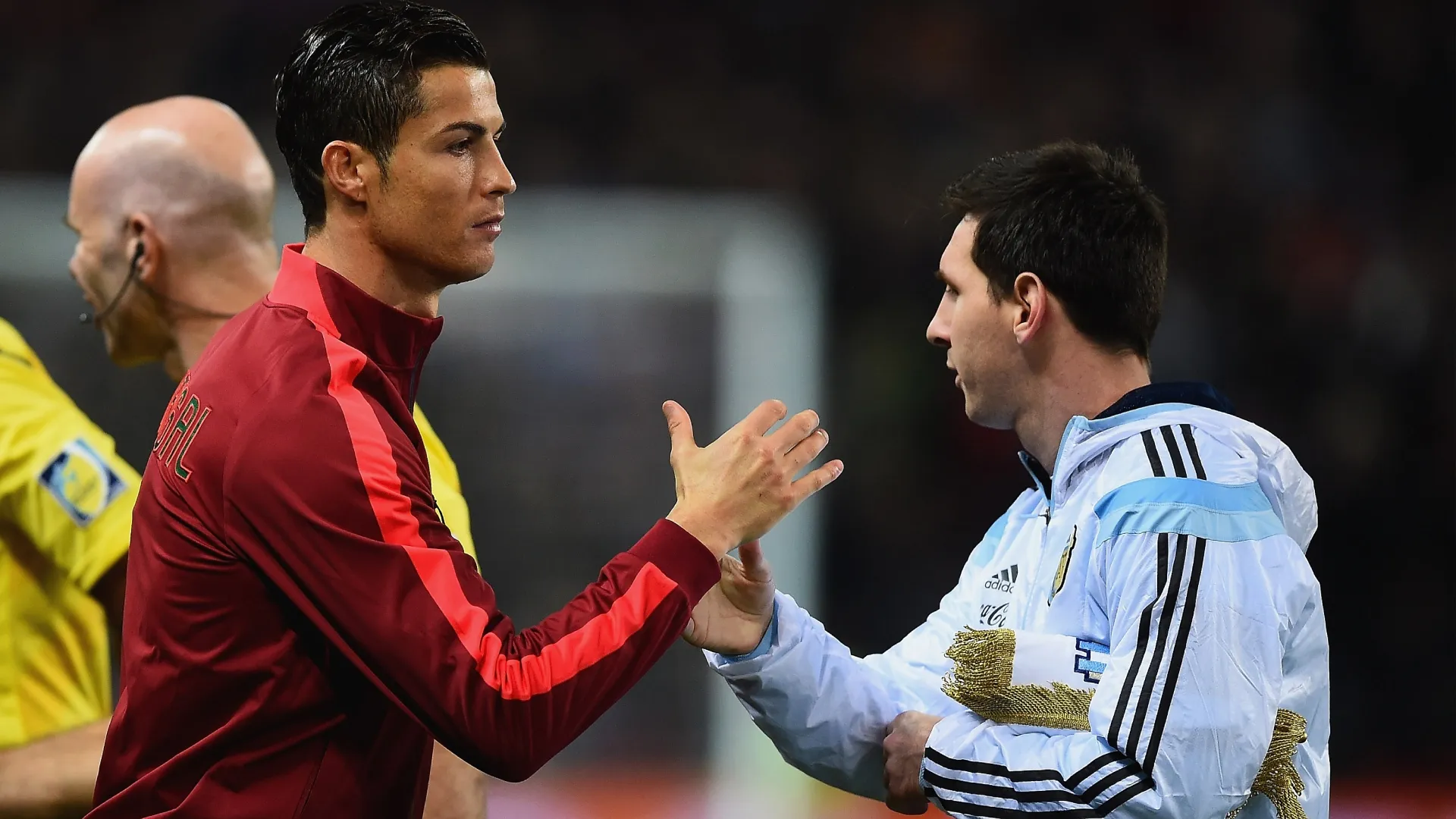 Cristiano Ronaldo of Portugal shakes hands with Lionel Messi of Argentina.