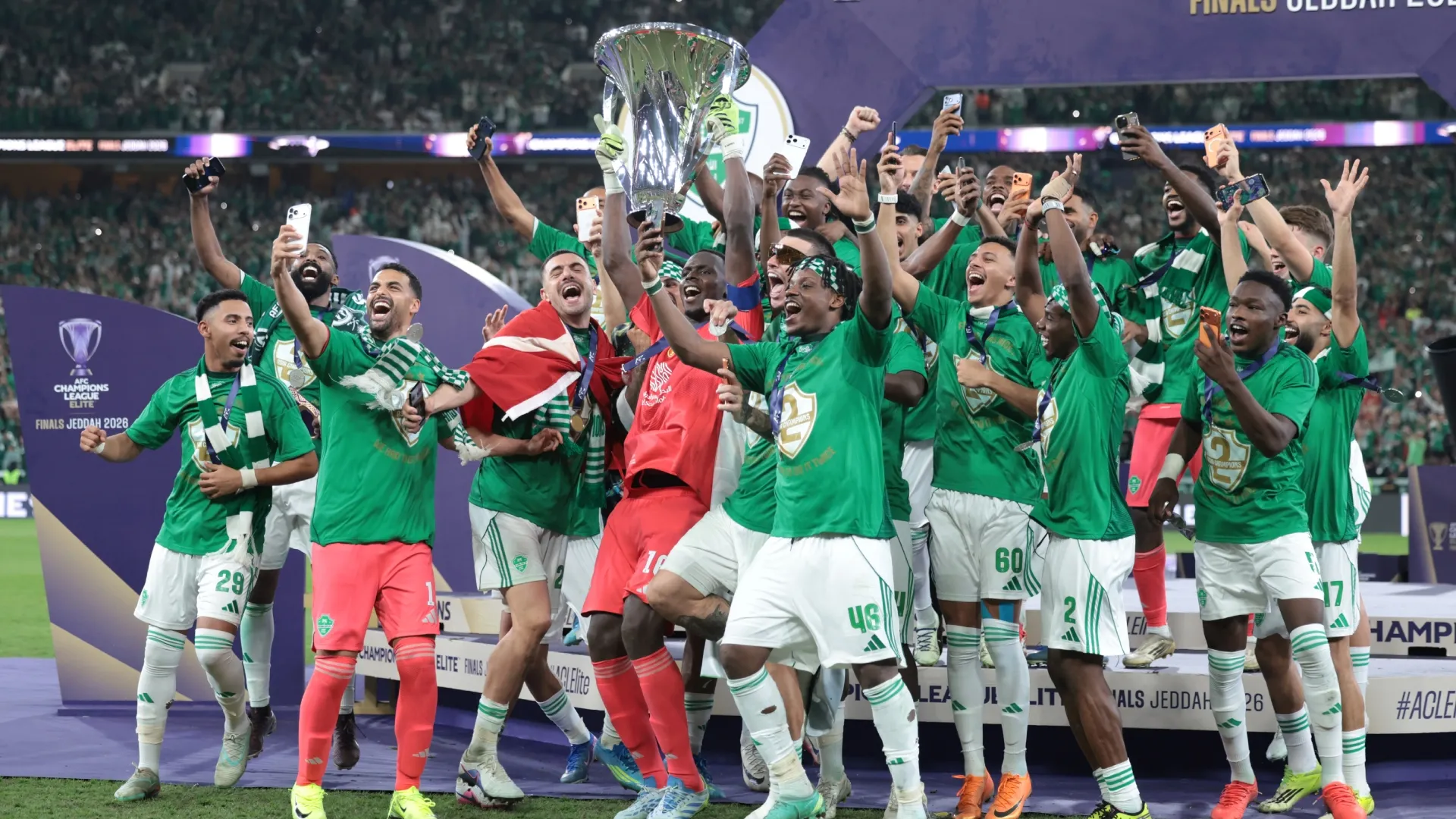 Edouard Mendy of Al Ahli lifts the AFC Champions League Elite trophy with teammates.