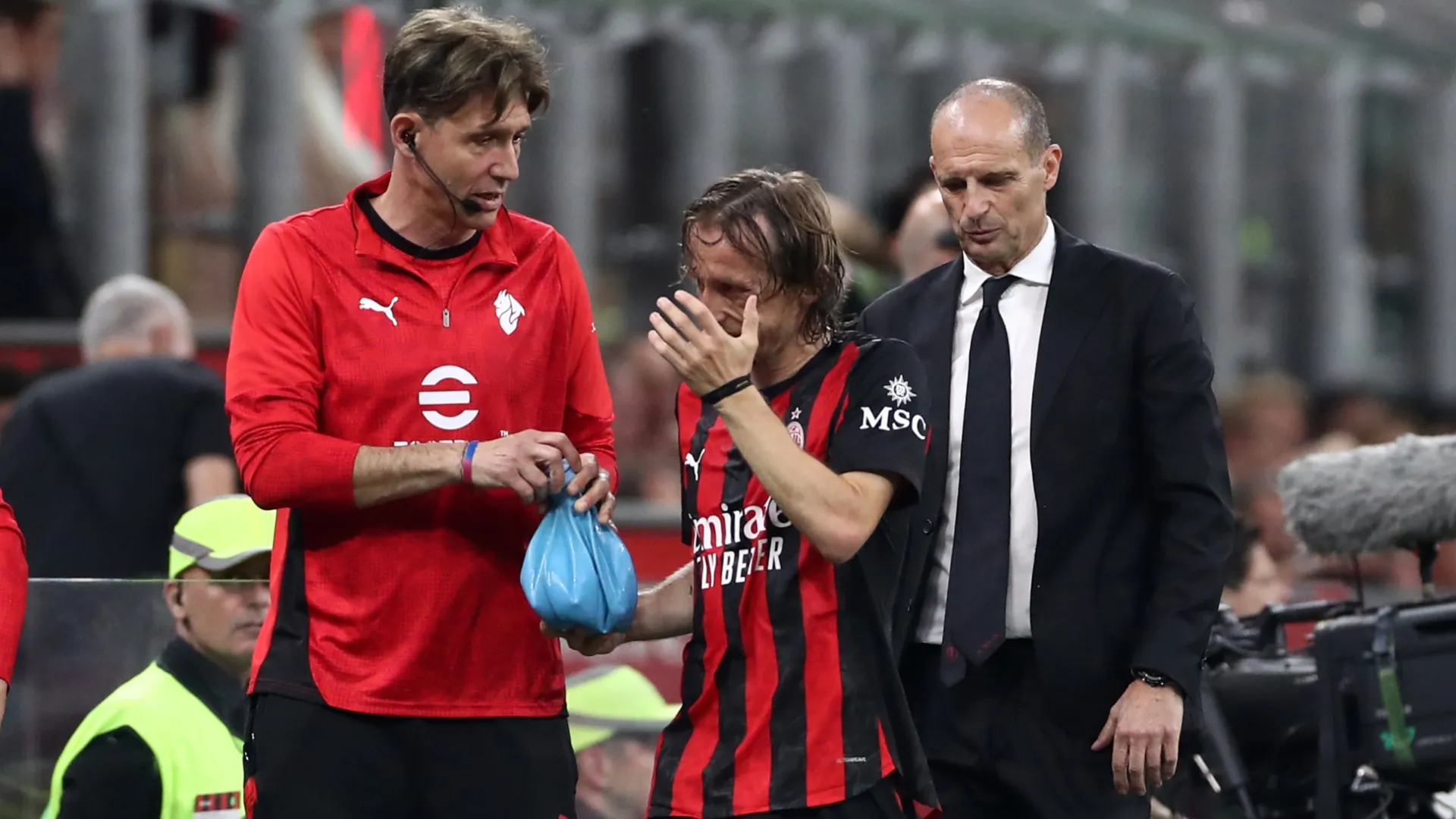 Luka Modric of AC Milan is assisted off by medical staff after going down injured.
