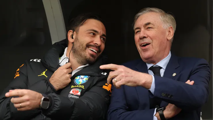 Carlo Ancelotti, Head Coach of Brazil, chats with his assistant coach Davide Ancelotti.