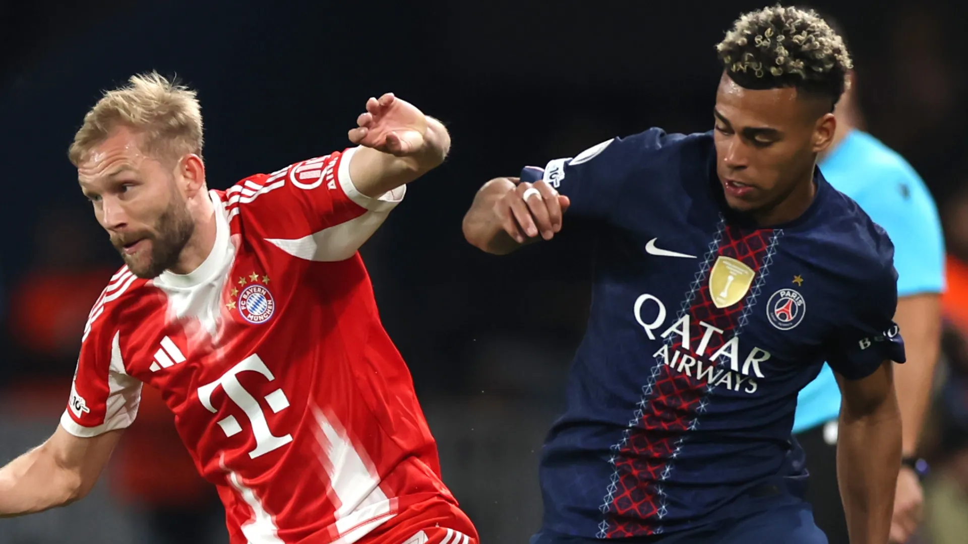 Konrad Laimer of FC Bayern Munich is challenged by Desire Doue of Paris Saint-Germain.