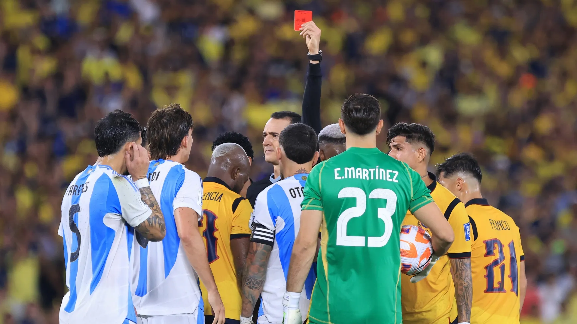 Referee Wilmar Roldan shows a red card to Nicolas Otamendi of Argentina.