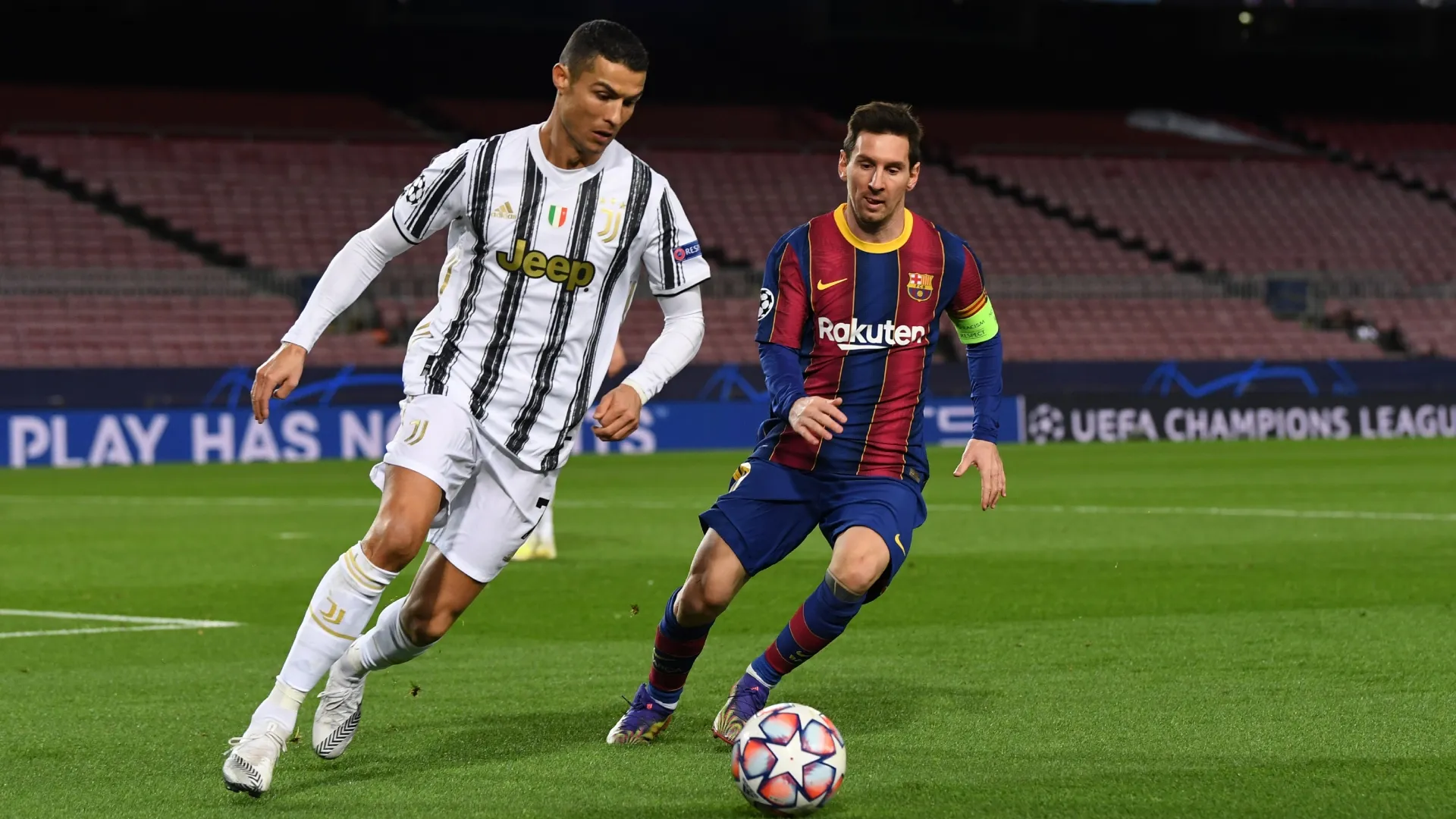 Cristiano Ronaldo of Juventus F.C. is put under pressure by Lionel Messi of Barcelona during the 2020-21 UEFA Champions League.