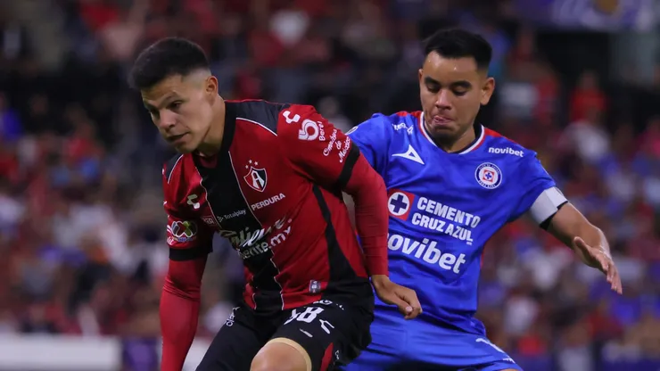 Arturo Gonzalez of Atlas fights for the ball with Carlos Rodriguez of Cruz Azul