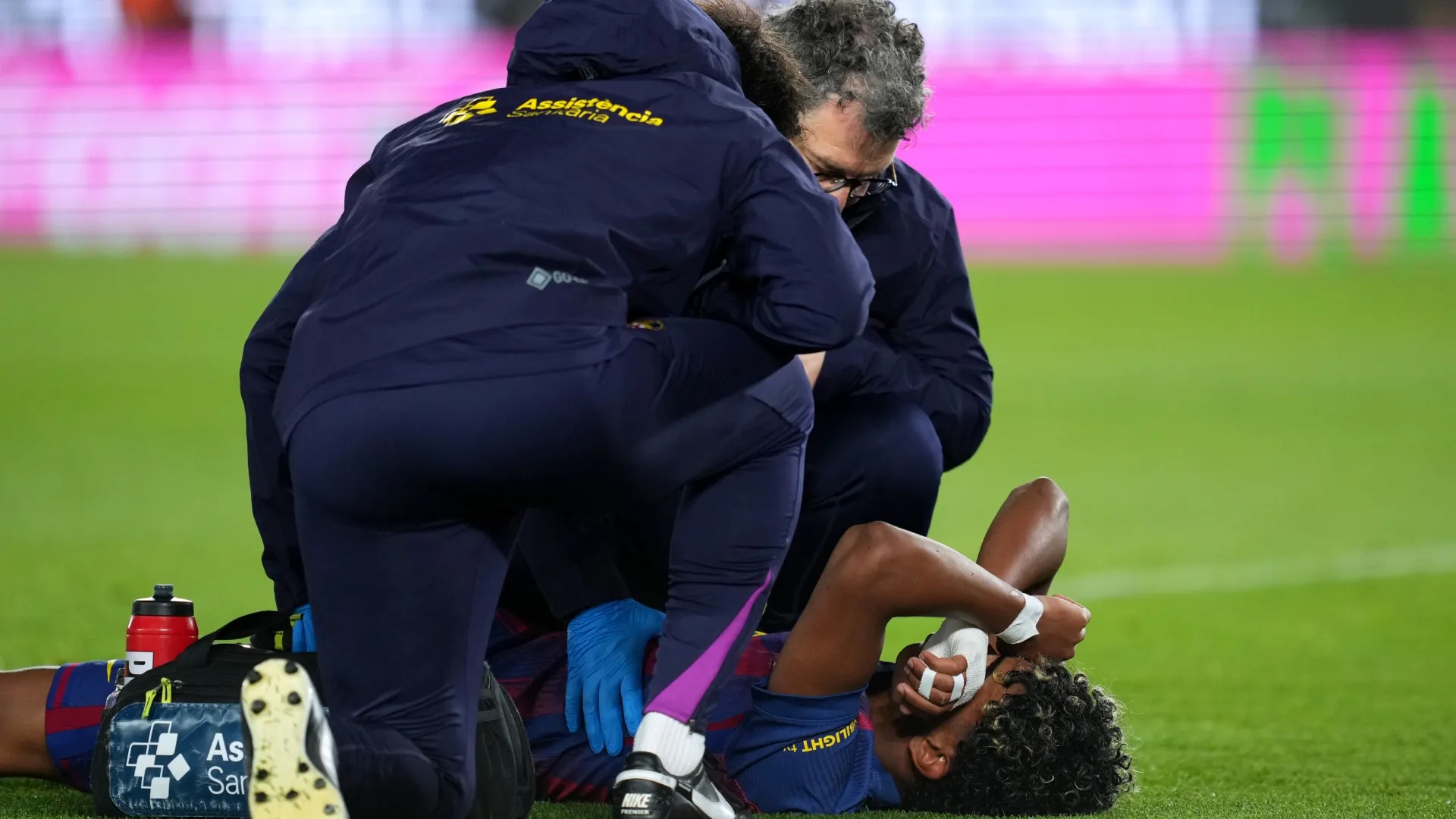 Lamine Yamal of FC Barcelona reacts to an injury.