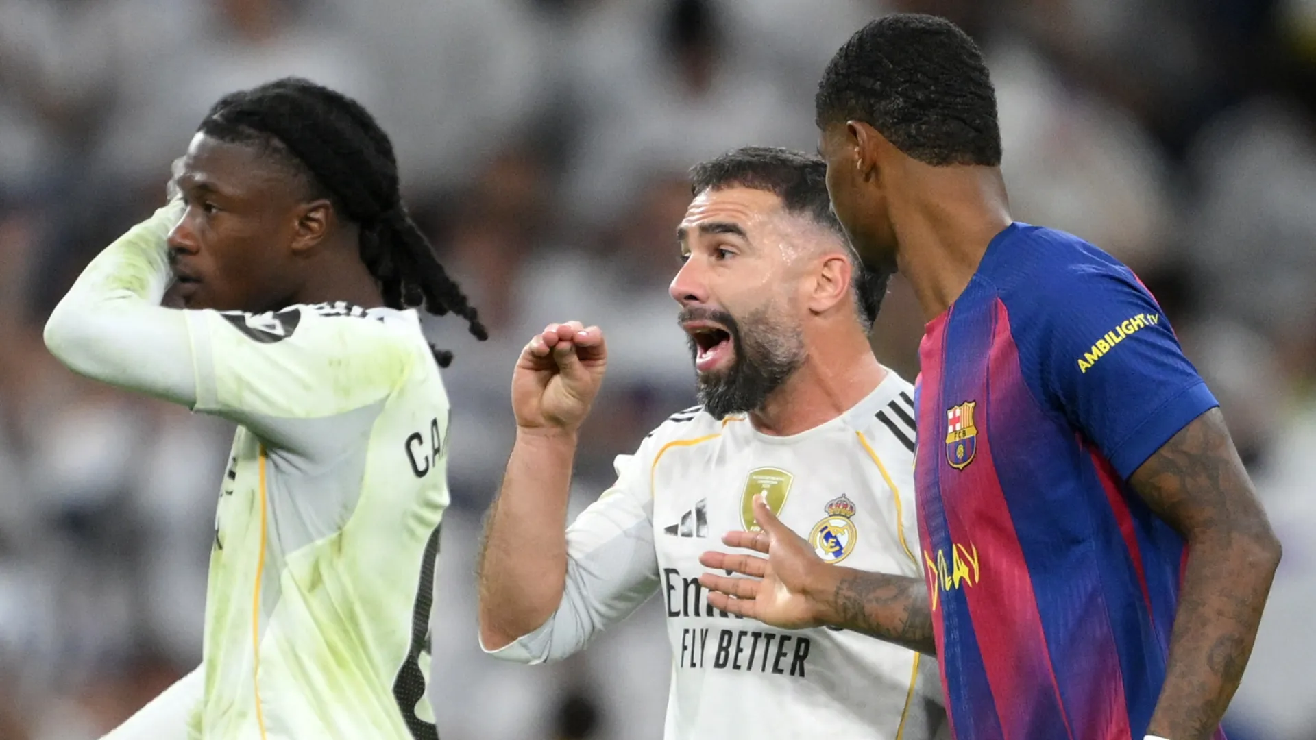 Dani Carvajal of Real Madrid gestures towards Lamine Yamal of FC Barcelona.