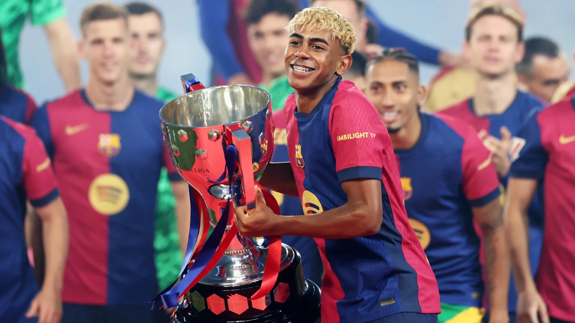 Lamine Yamal of FC Barcelona lifts the La Liga title trophy.