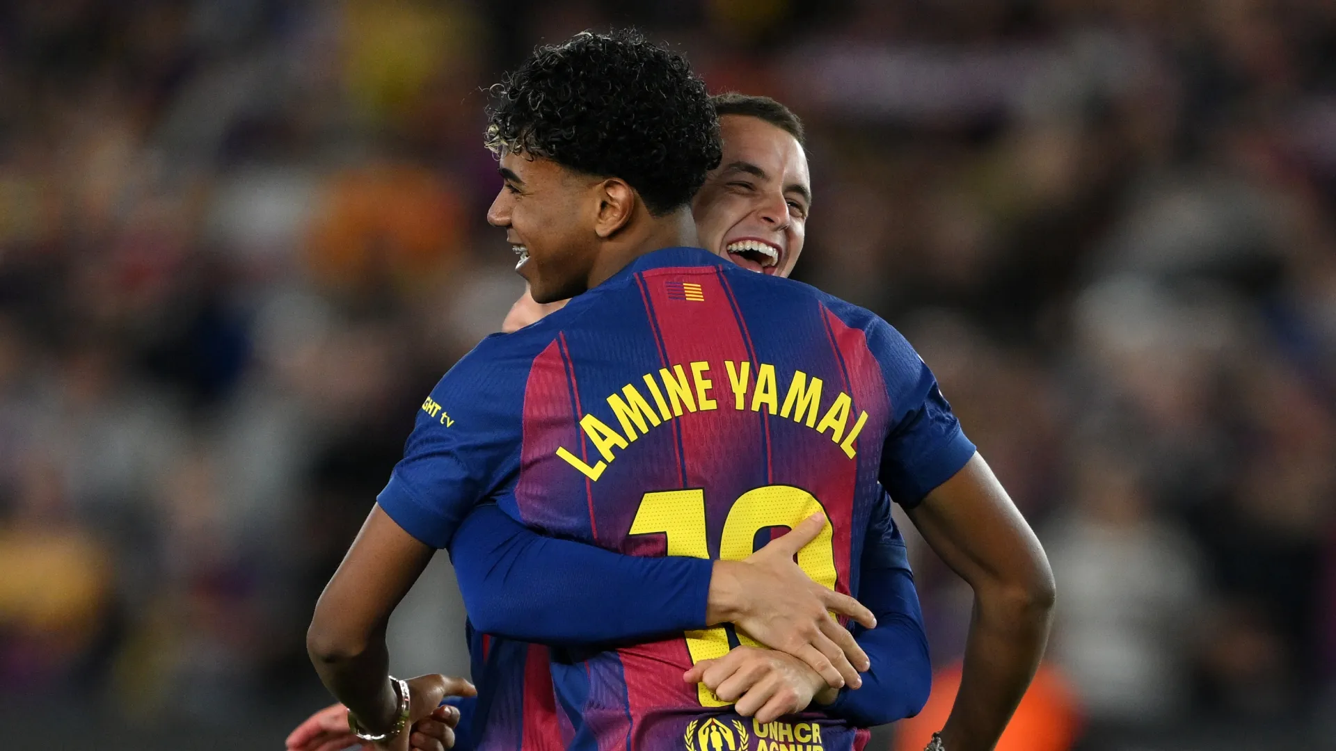 Lamine Yamal of FC Barcelona celebrates with teammate Marc Casado after defeating Real Madrid.