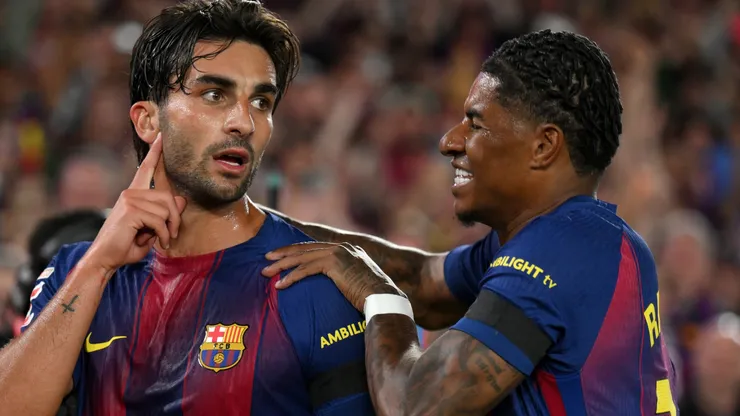 Ferran Torres of FC Barcelona celebrates with Marcus Rashford after scoring a goal.