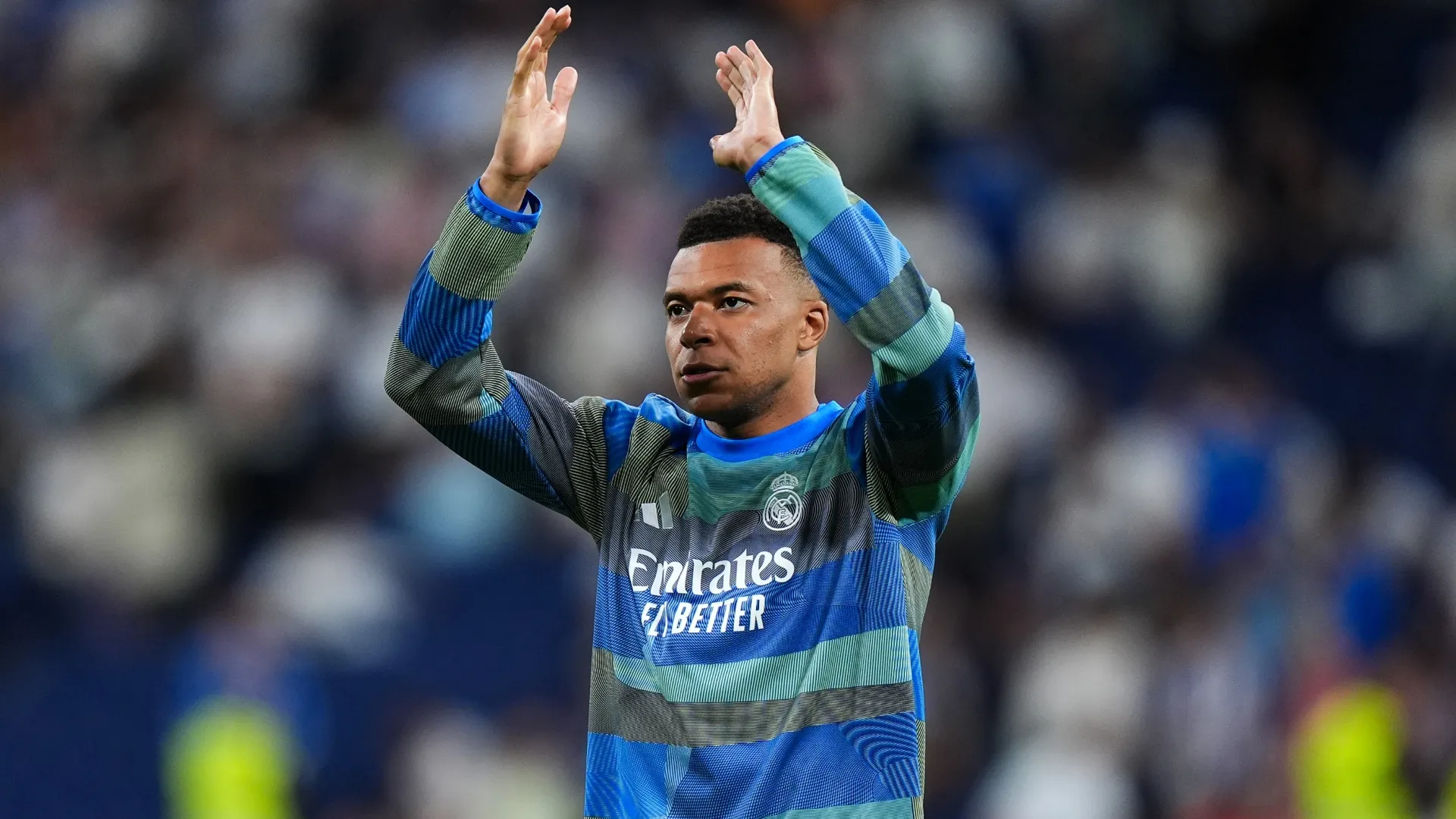 Kylian Mbappe of Real Madrid applauds the fans at the Santiago Bernabeu.