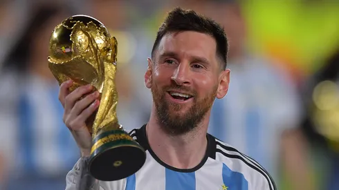 Lionel Messi holds the World Cup trophy.