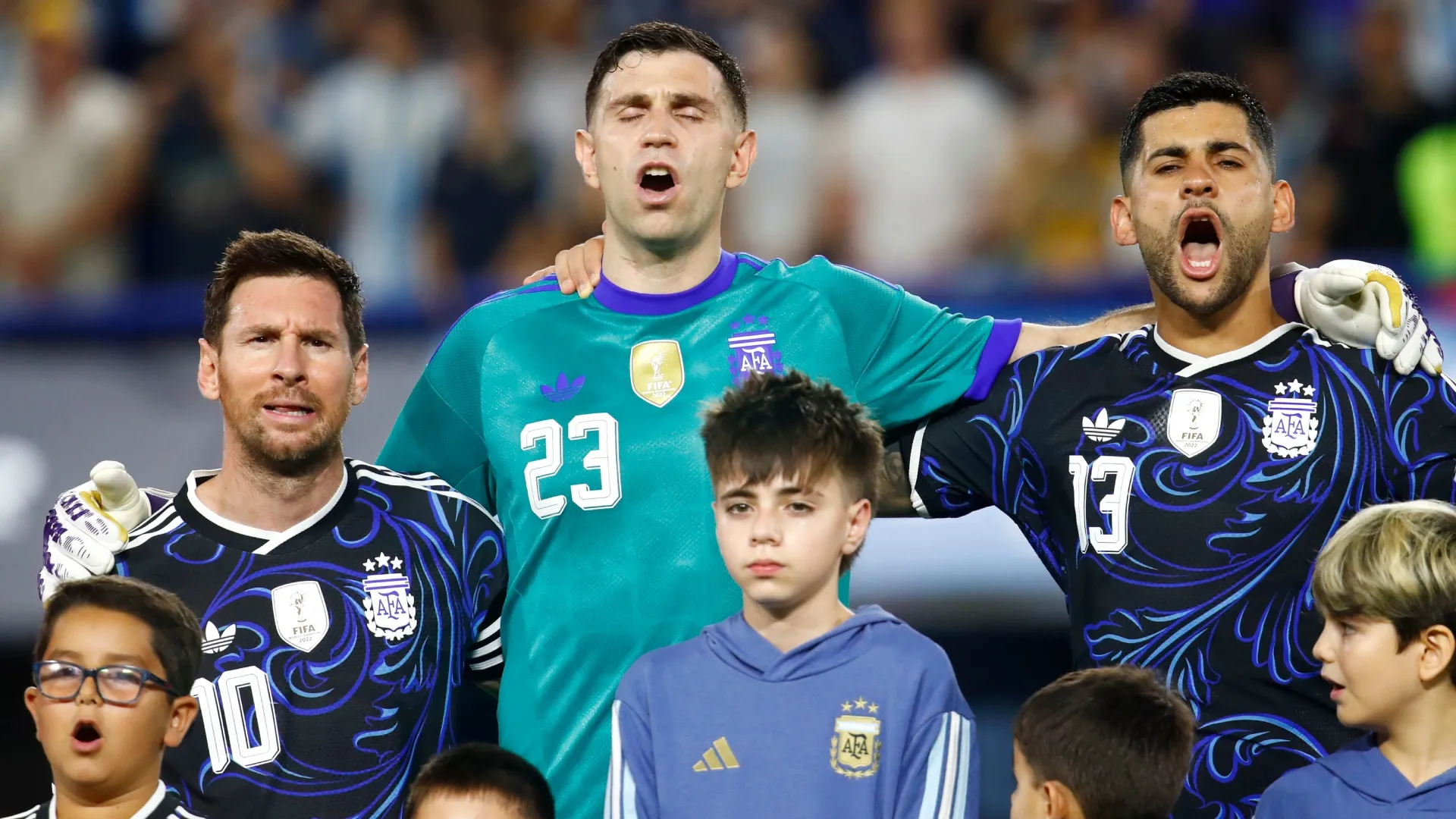 Lionel Messi, goalkeeper Emiliano Martinez and Cristian Romero of Argentina sing the national anthem.