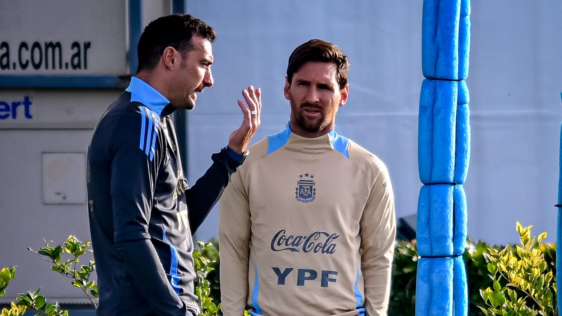 Lionel Scaloni head coach of Argentina talks with Lionel Messi prior to a training session.