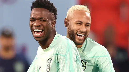 Neymar of Brazil jokes with team mate Vinicius Junior.