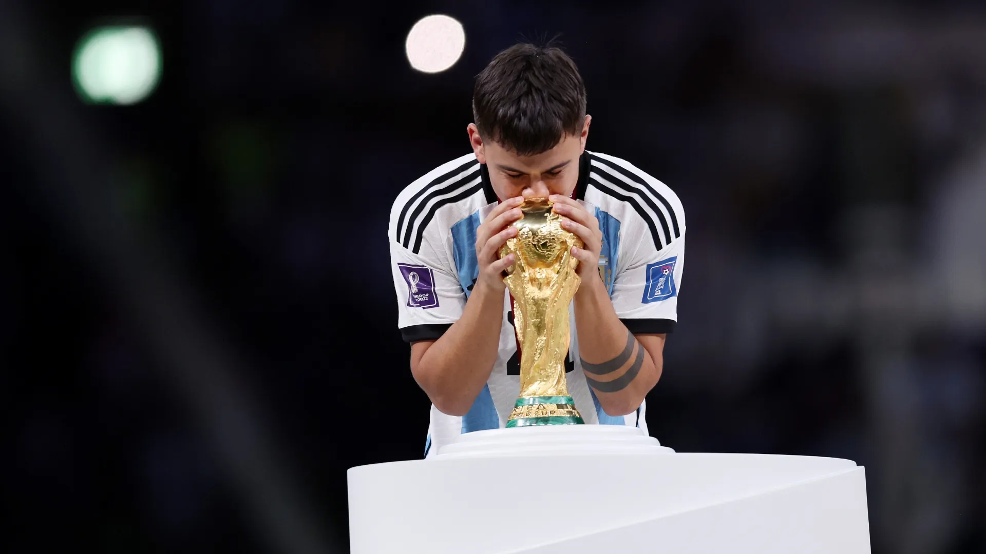 Paulo Dybala of Argentina kisses the FIFA World Cup winning trophy.