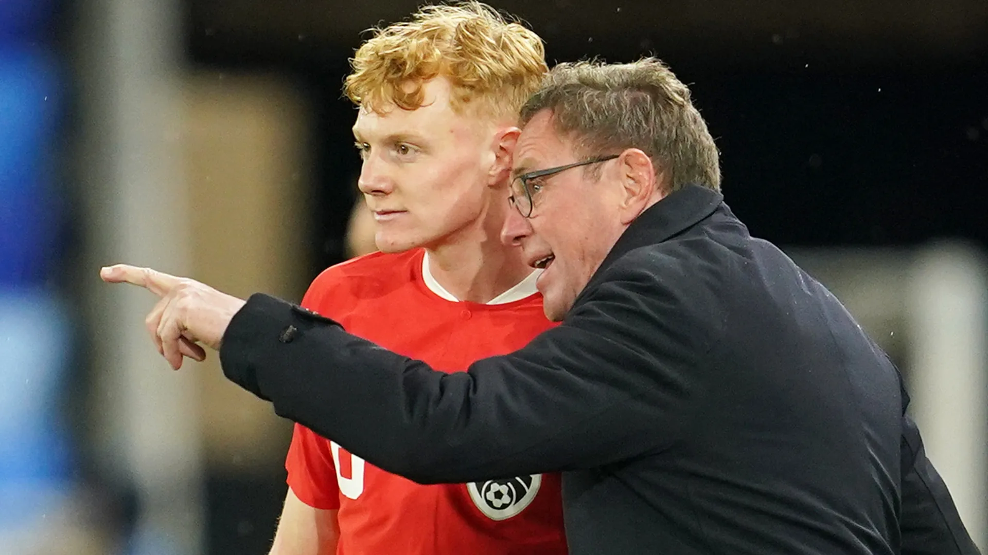 Ralf Rangnick, Head Coach of Austria, interacts with his player, Nicolas Seiwald.