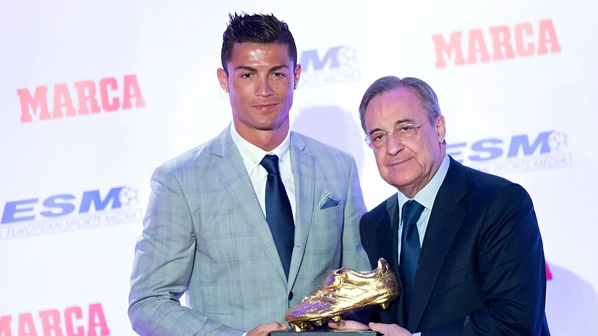 Real Madrid football player Cristiano Ronaldo (L) receives from hands of Real Madrid president Florentino Perez (R) his fourth Golden Boot Award.