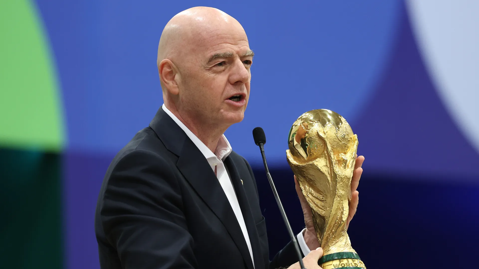 FIFA President Gianni Infantino holds the FIFA World Cup trophy.