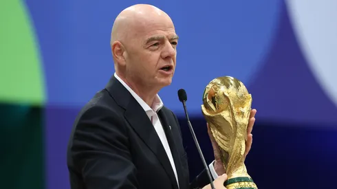 FIFA President Gianni Infantino holds the FIFA World Cup trophy.