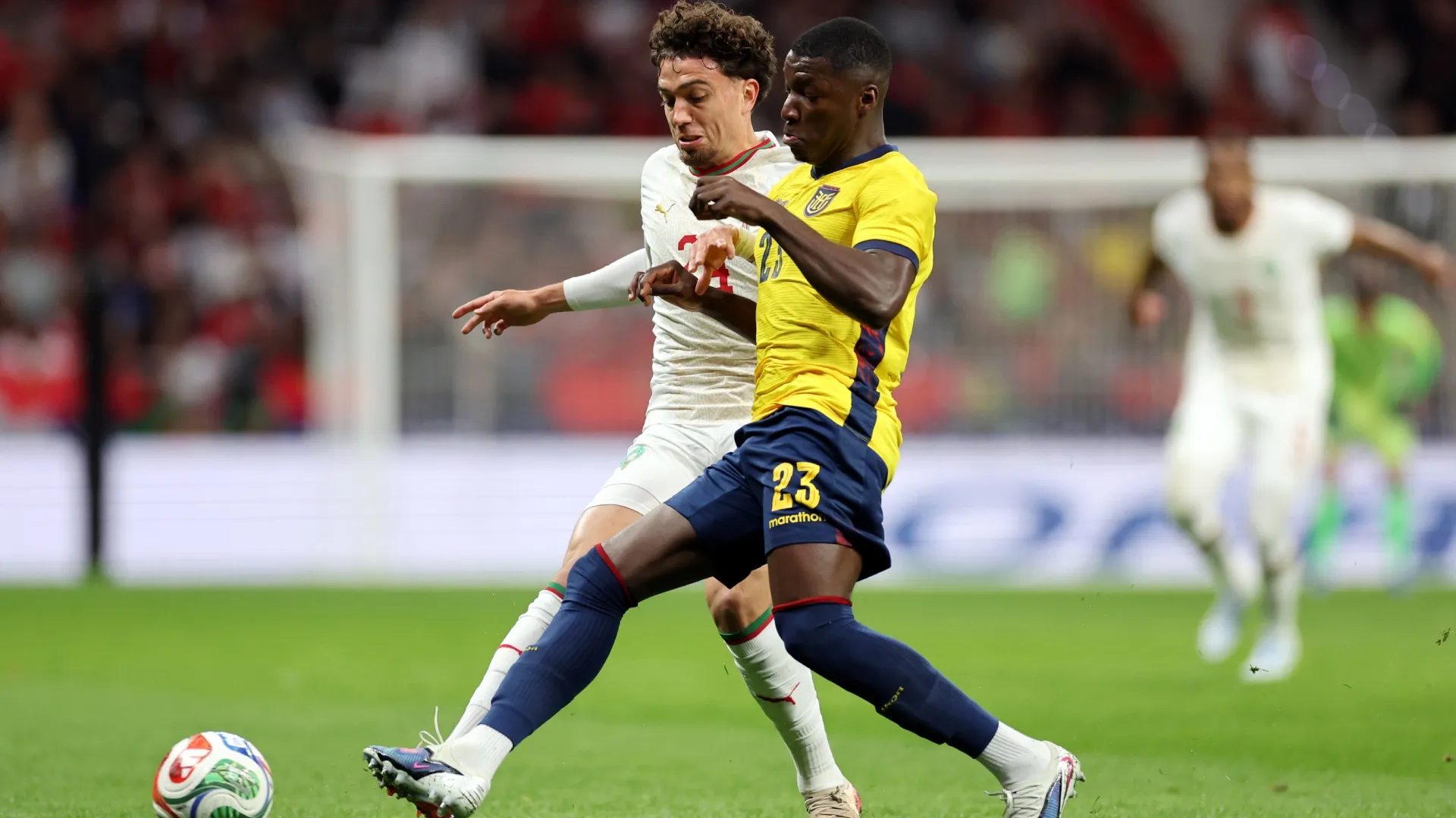Neil Al Aynaooui of Morocco is challenged by Moises Caicedo of Ecuador.