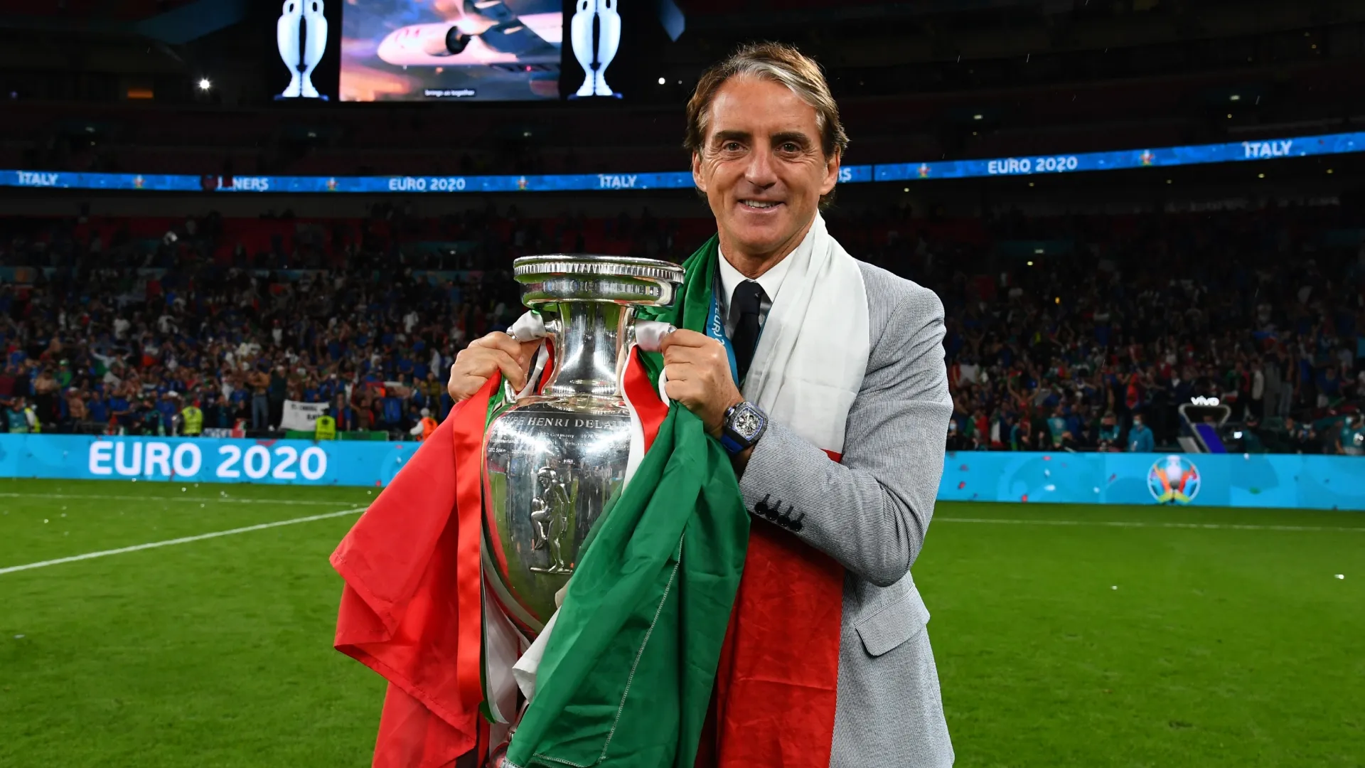 Coach Roberto Mancini of Italy celebrates with The Henri Delaunay Trophy.