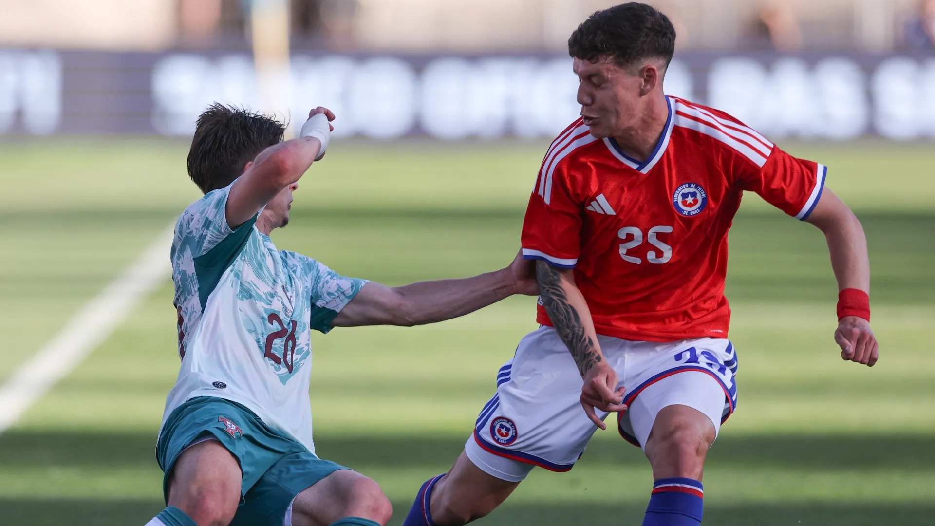 Francisco Conceicao #26 of Portugal battles for possession Agustin Arce #25 of Chile.