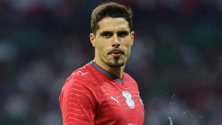 Pedro Neto of Portugal looks on.