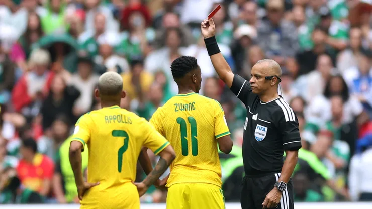 Referee Wilton Sampaio issues a red card to Themba Zwane #11 of South Africa.