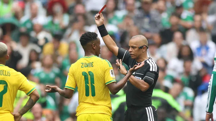 Referee Wilton Sampaio issues a red card to Themba Zwane #11 of South Africa.
