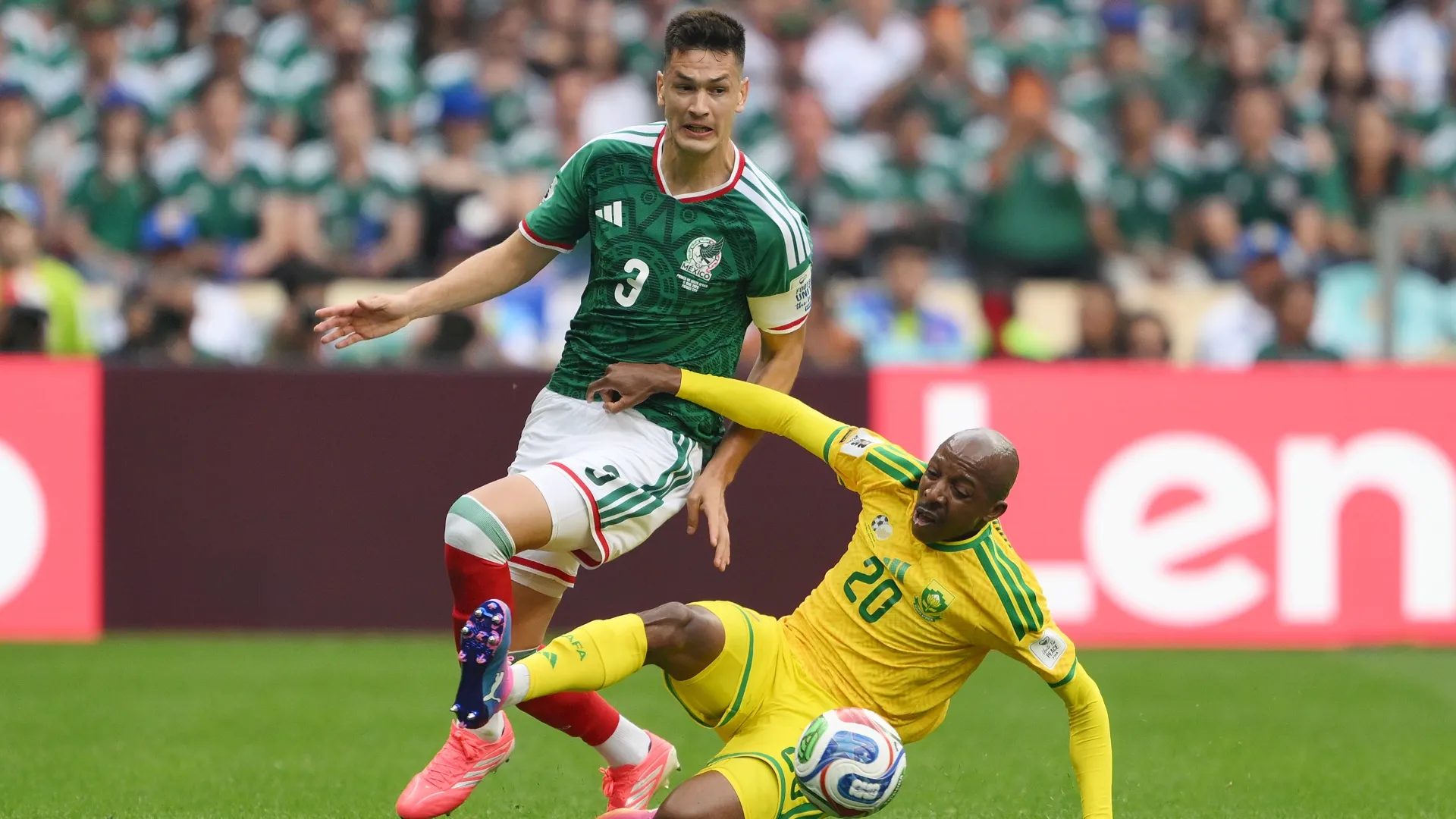 Cesar Montes #3 of Mexico is tackled by Khuliso Mudau #20 of South Africa.