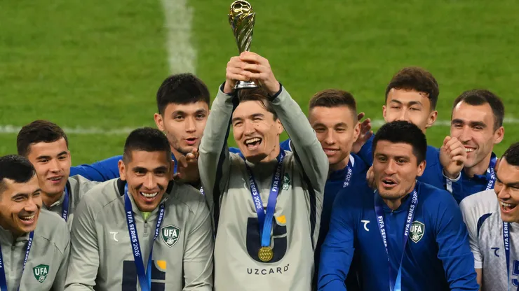 Eldor Shomurodov of Uzbekistan lifts the FIFA Series 2026 trophy with team mates.