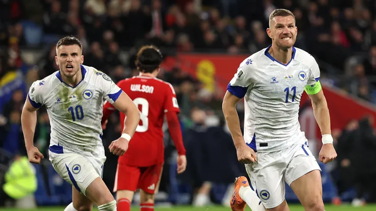 Edin Dzeko (R) of Bosnia and Herzegovina celebrates after scoring.