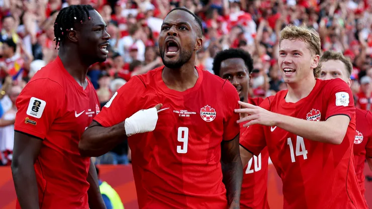 Cyle Larin #9 of Canada celebrates with teammates after scoring the team's first goal
