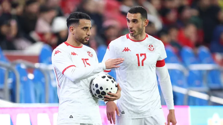 Ellyes Skhiri #17 of Tunisia speaks to teammate Mohamed Hadj Mahmoud.
