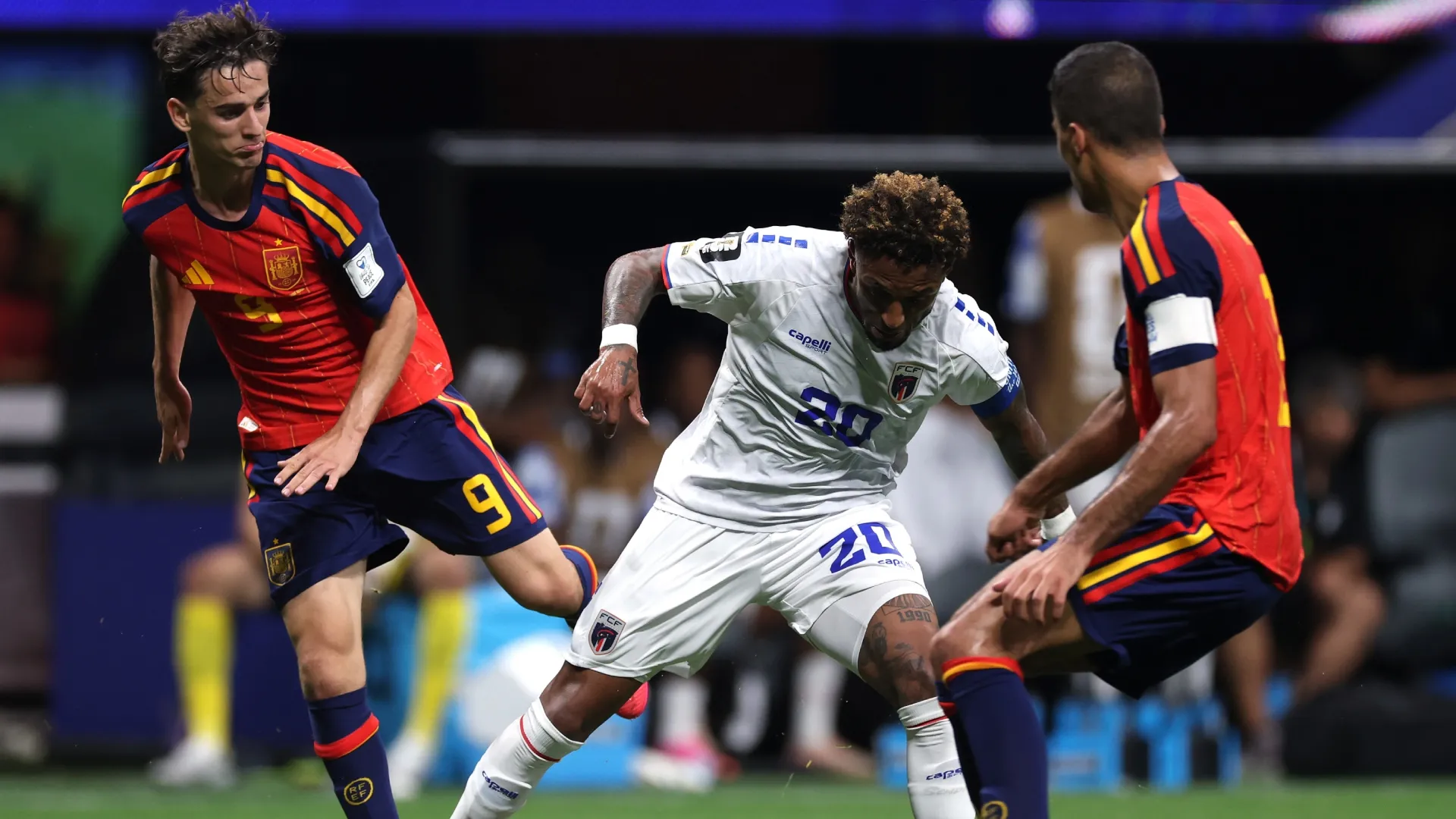 Ryan Mendes #20 of Cabo Verde controls the ball under pressure from Gavi #9 and Rodri #16 of Spain.