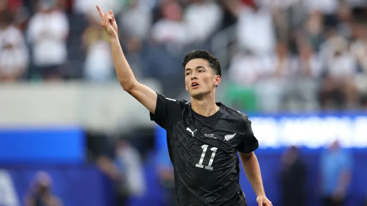 Elijah Just #11 of New Zealand celebrates scoring against Iran.