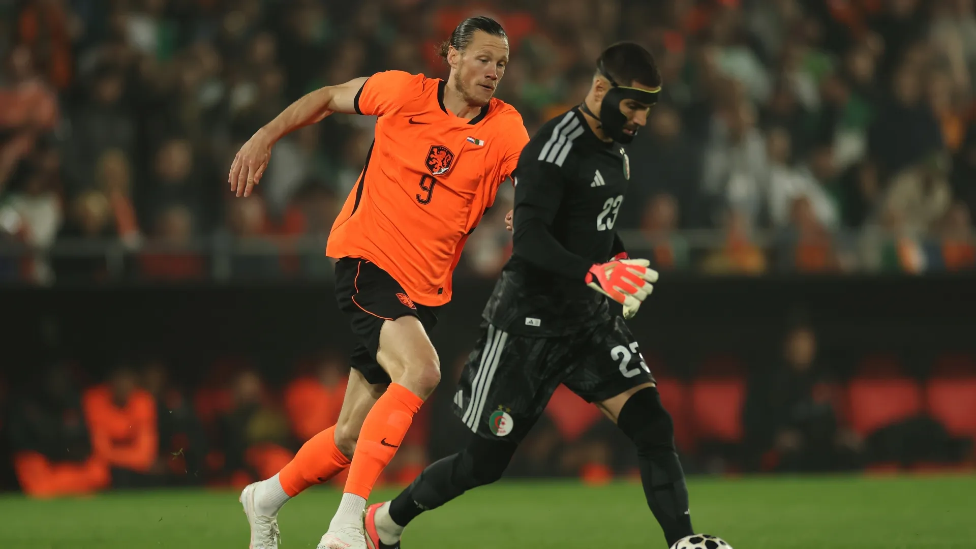 Wout Weghorst of Netherlands chases Goalkeeper, Luca Zidane of Algeria.