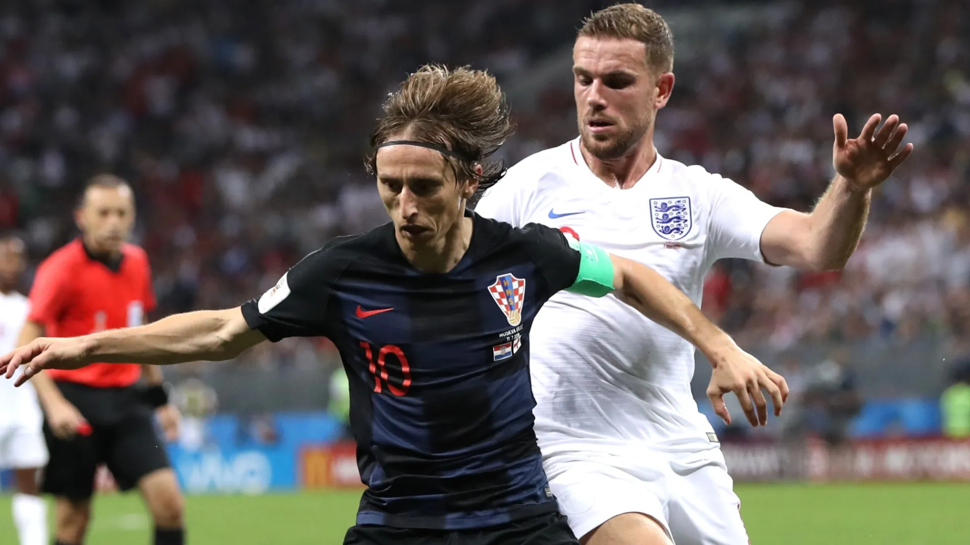 Luka Modric of Croatia is challenged by Jordan Henderson of England during the 2018 FIFA World Cup.