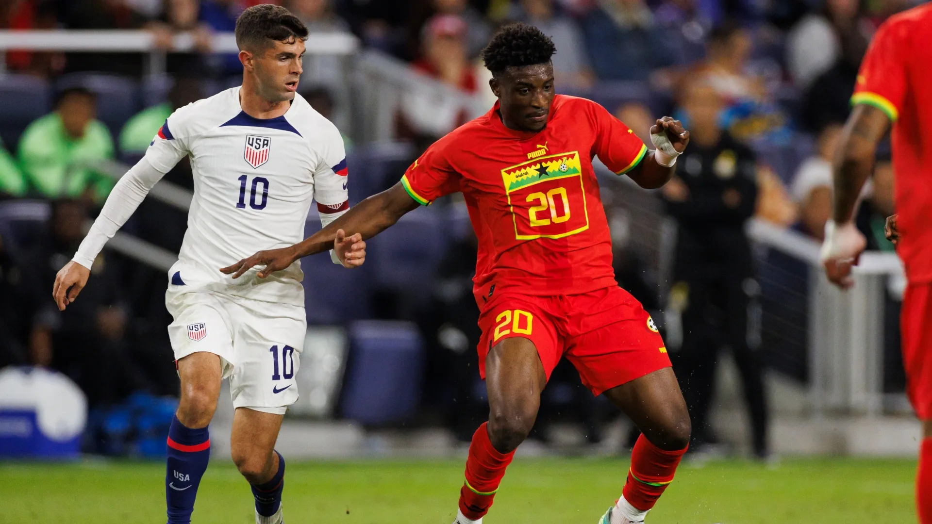 Christian Pulisic #10 of United States challenges Mohammed Kudus #20 of Ghana.