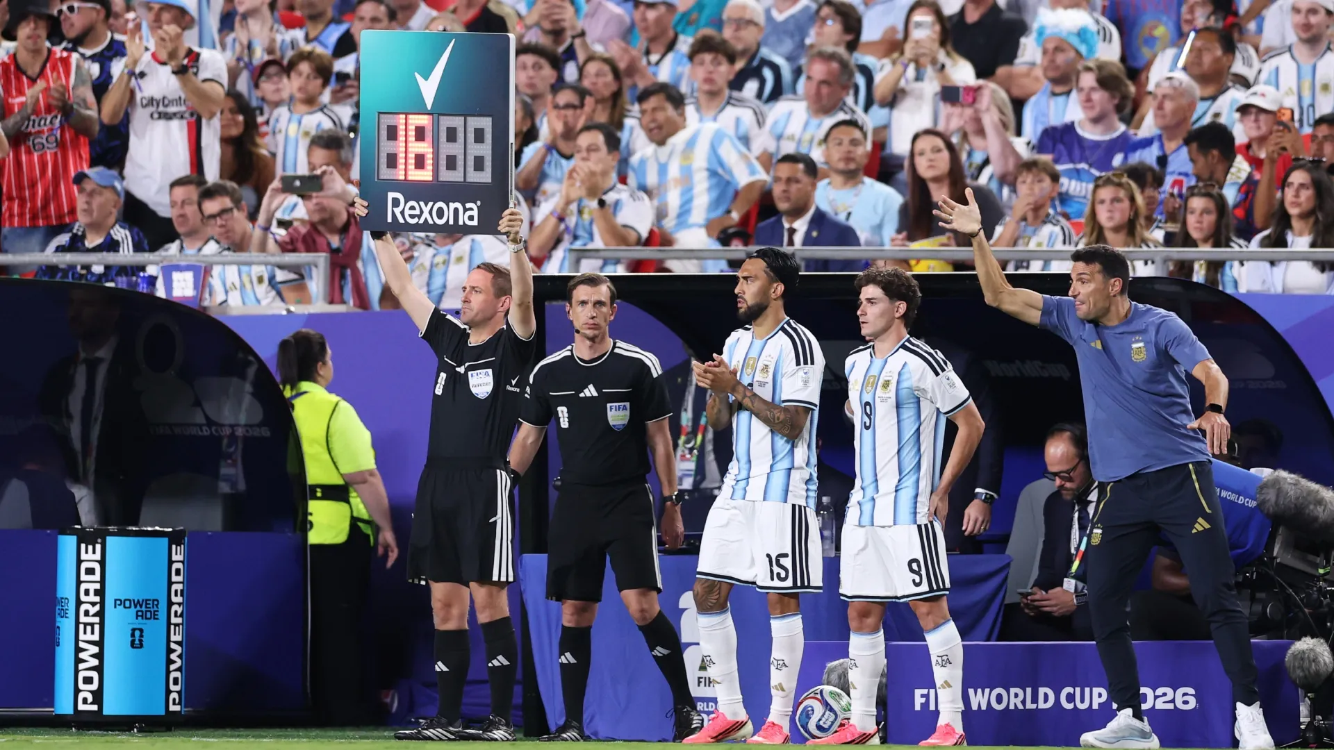 Nico Gonzalez #15 and Julian Alvarez #9 of Argentina stand on the touchline before coming on as substitutes.