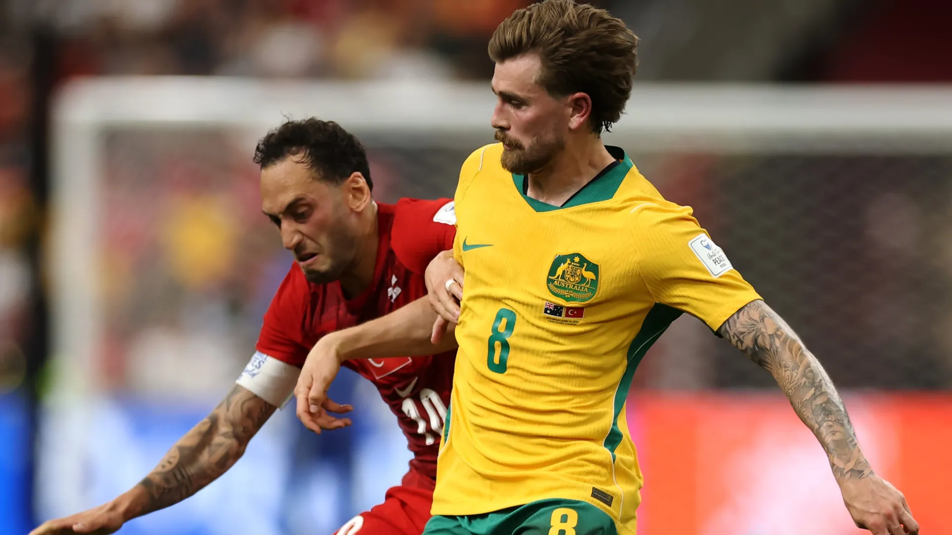 Connor Metcalfe of Australia battles for the ball with Hakan Calhanoglu of Turkiye.