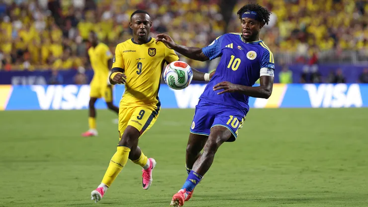 Leandro Bacuna #10 of Curacao controls the ball under pressure from John Yeboah #9 of Ecuador.